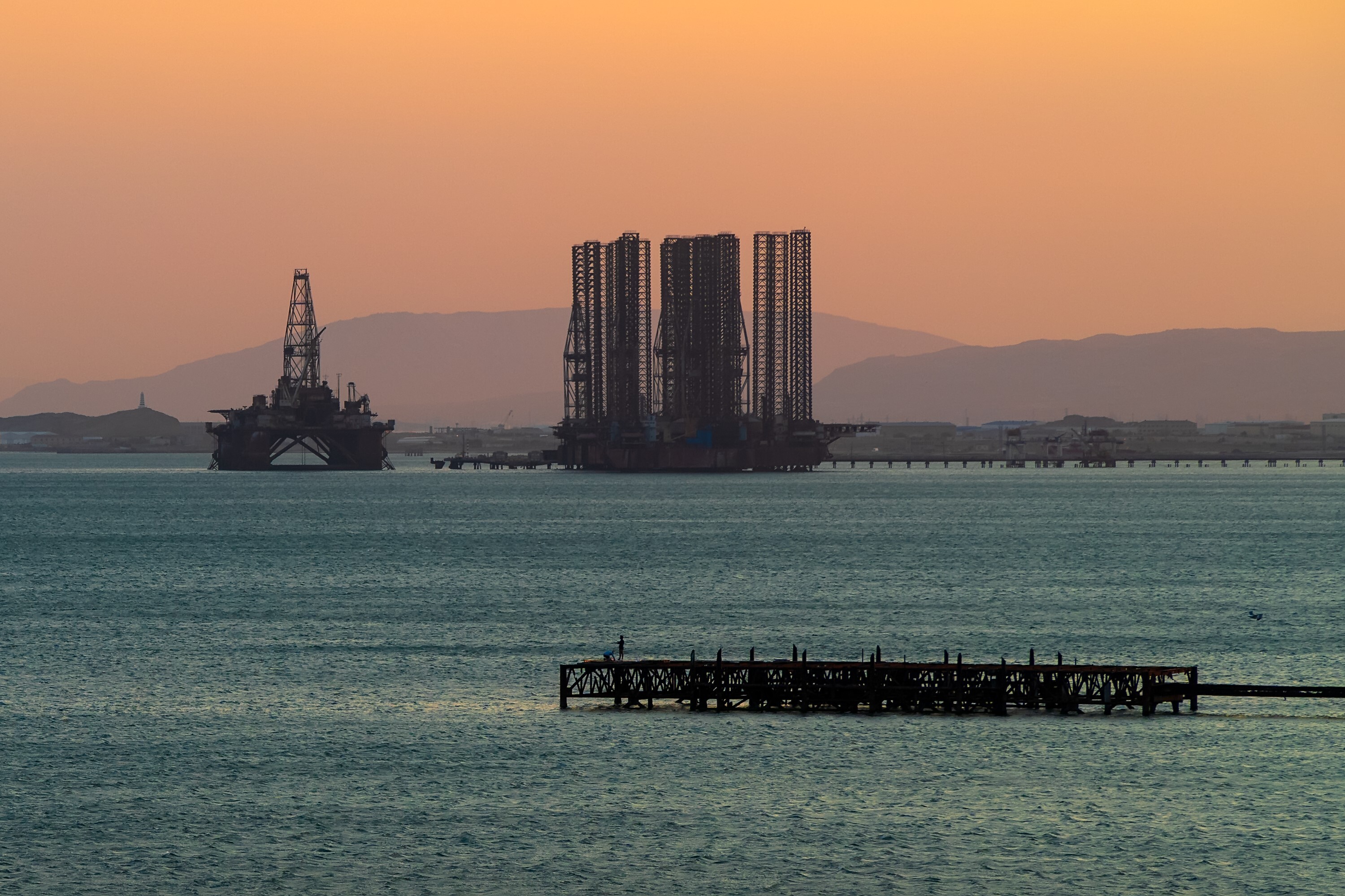 Oil platforms in the sea at sunset 2026 01 09 11 05 10 utc